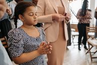 A Girl in a Blue Dress Praying Intimately