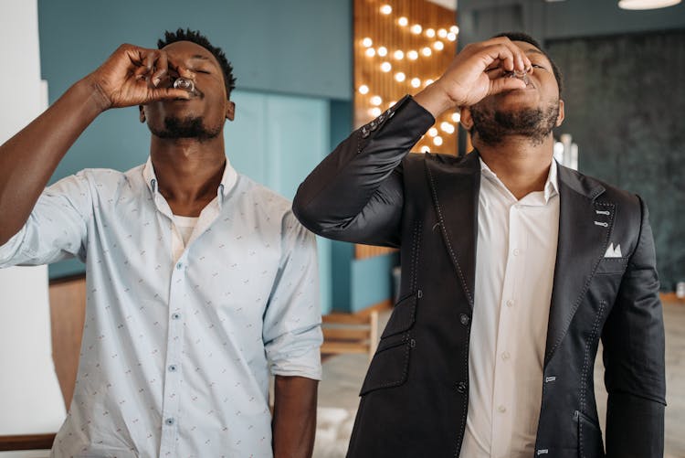 Men Drinking Wine In A Small Glass