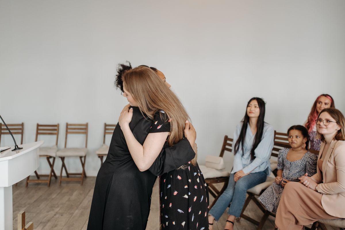 Women supporting one another in a group setting