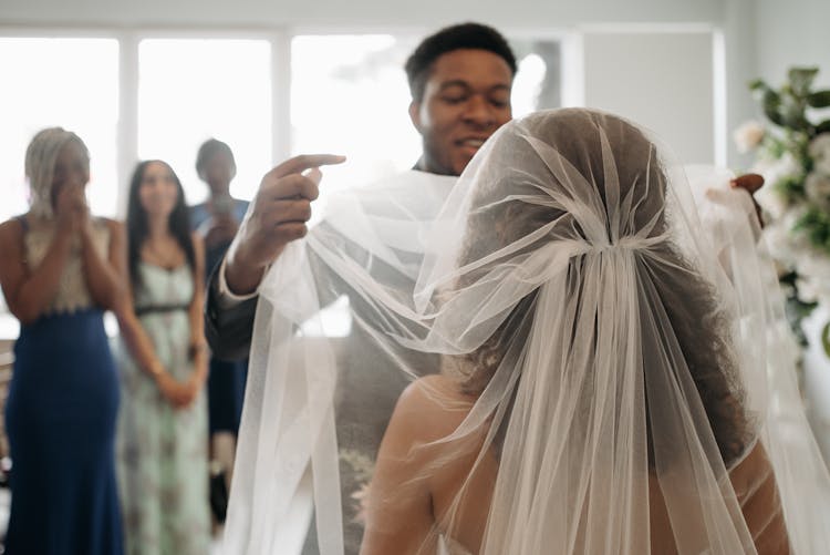 Groom Lifting The Veil Of The Bride