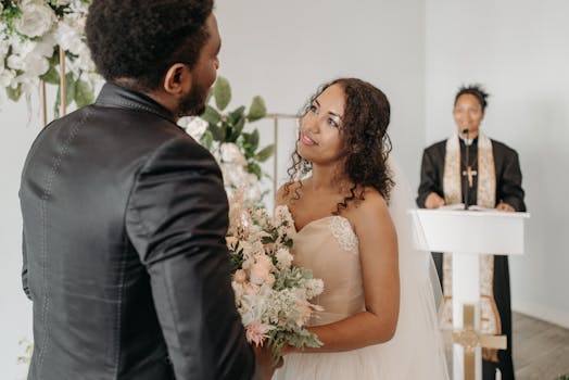 A touching wedding ceremony featuring a bride and groom exchanging vows indoors with a pastor officiating.