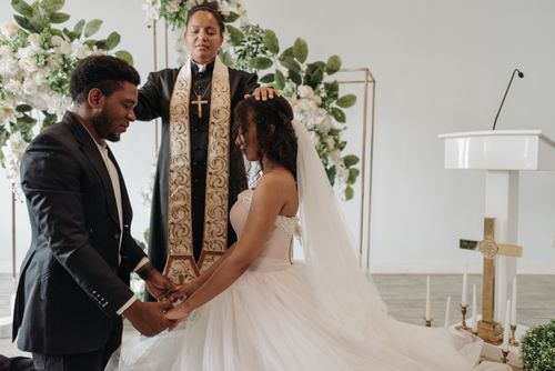 Free Bride and groom receiving blessings in a beautifully decorated wedding ceremony. Stock Photo