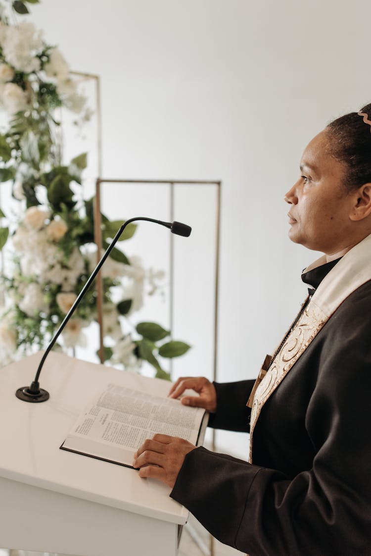 Woman Pastor Standing Behind A Lectern 