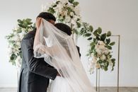 Man and Woman Kissing Near Green Plant