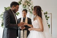 Man in Black Suit Kissing Woman in White Wedding Dress