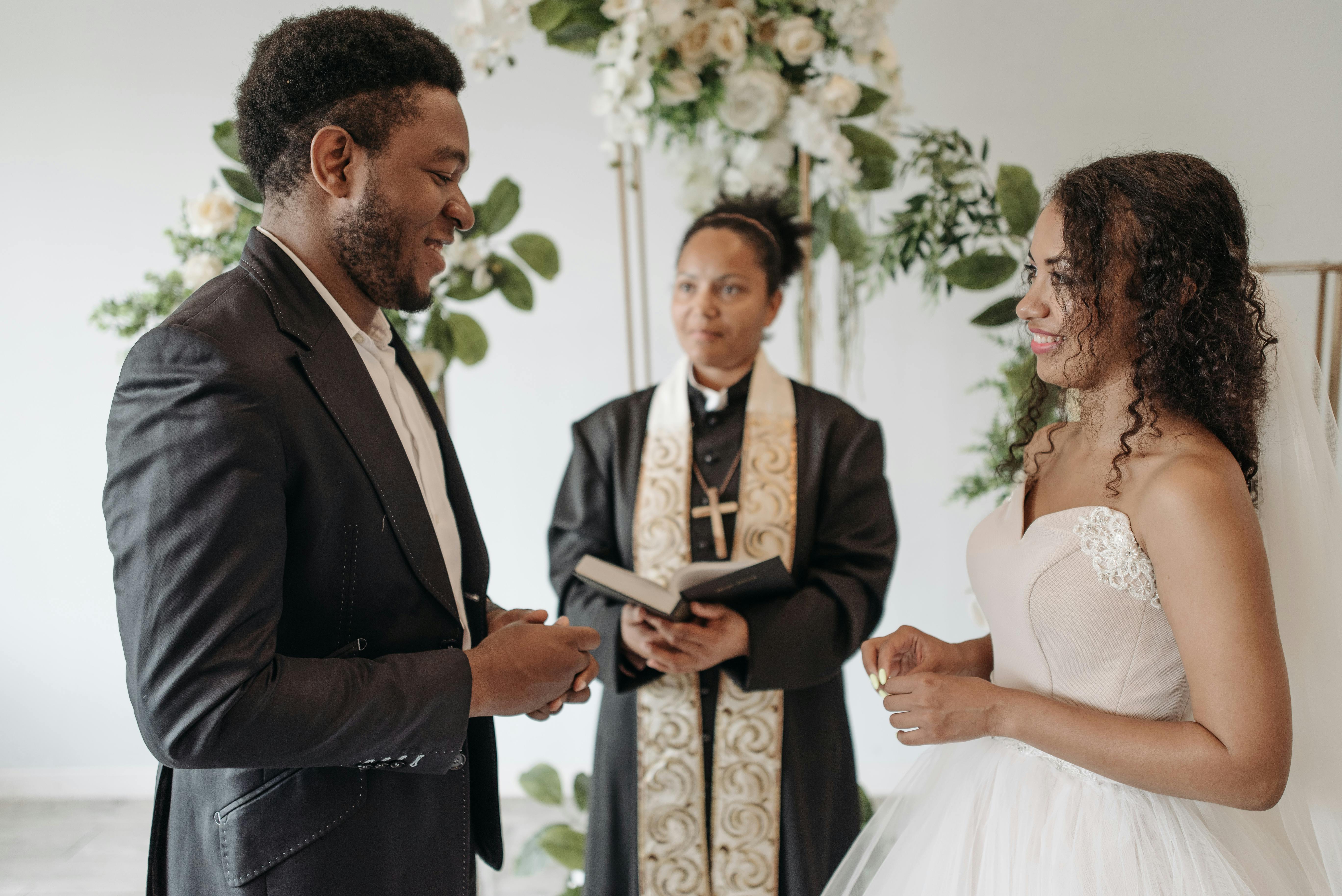 a woman pastor celebrating a couples wedding vows