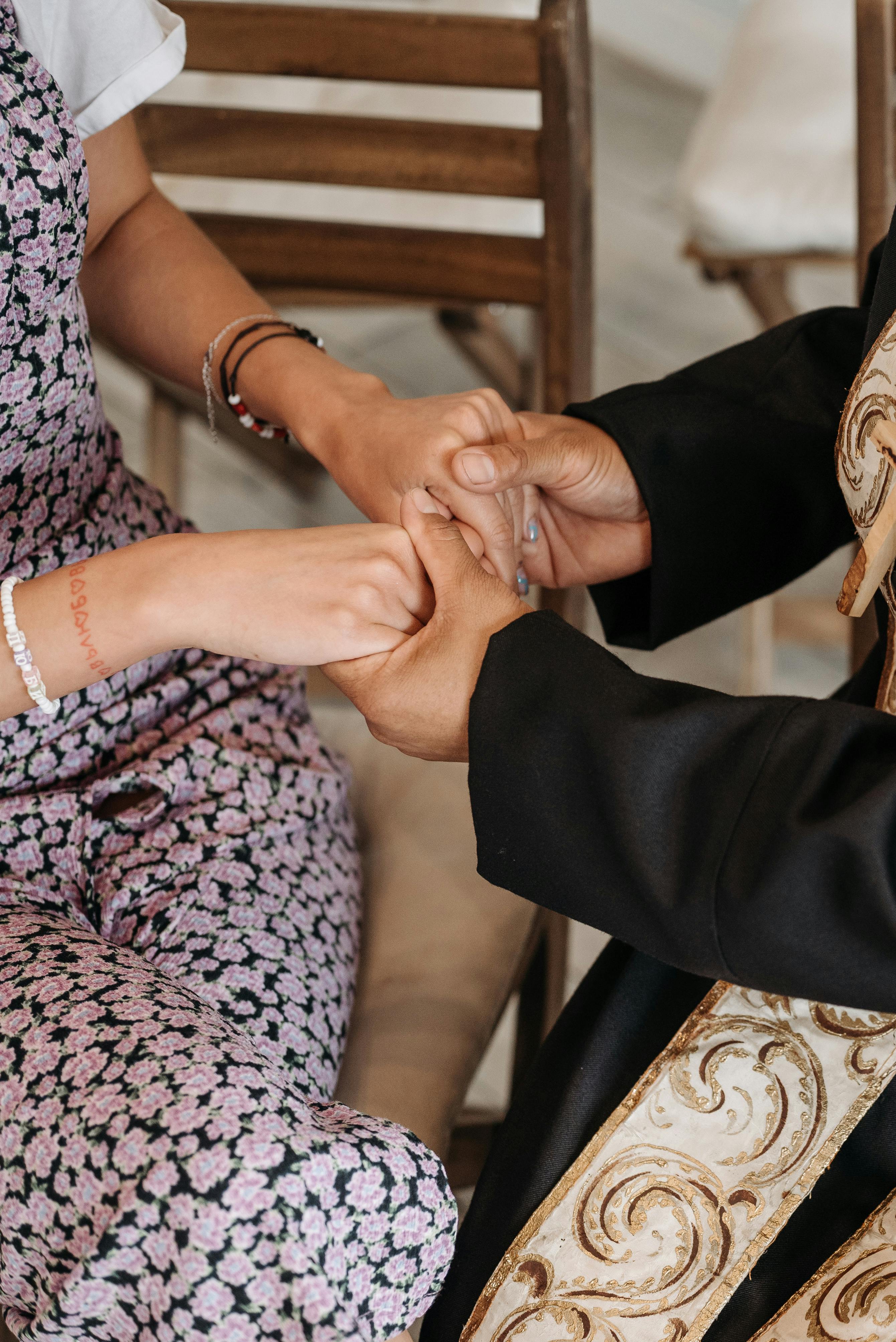 pastor holding hands of a woman