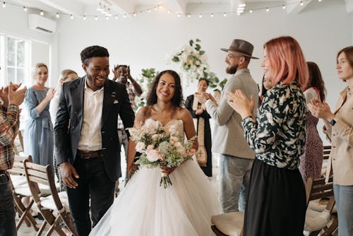 Free Woman in White Wedding Gown Holding Bouquet of Flowers Stock Photo