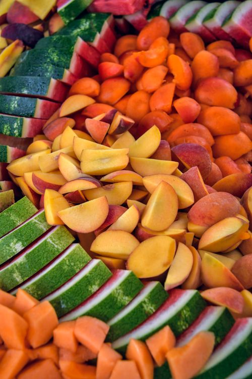 Free Colorful array of freshly sliced watermelon, apricots, and other fruits. Perfect for healthy eating and food photography. Stock Photo