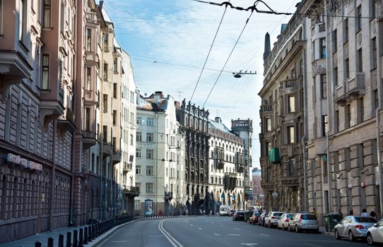 Charming architecture along a quiet street in St. Petersburg, Russia, under a bright sky.
