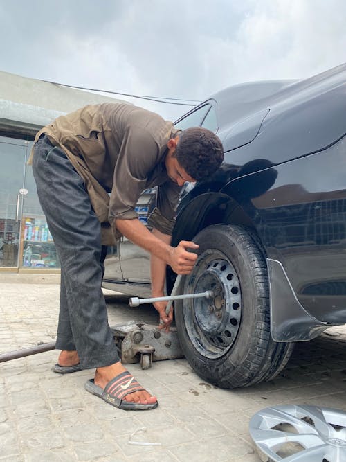 Man Changing Vehicle Tire