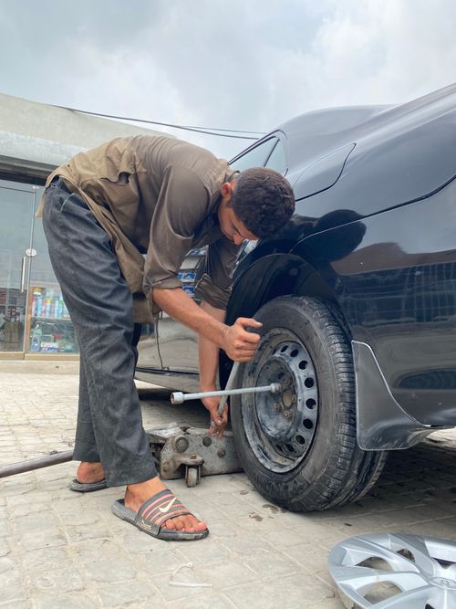 Technician changing a tire on the roadside
