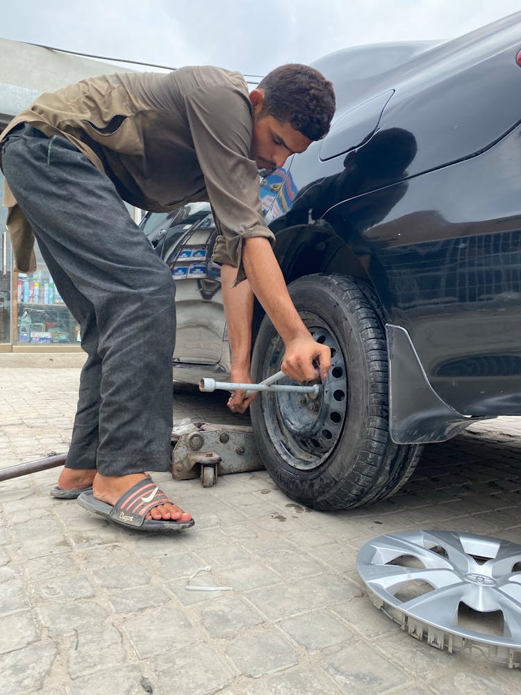 Man Using A Lug Wrench