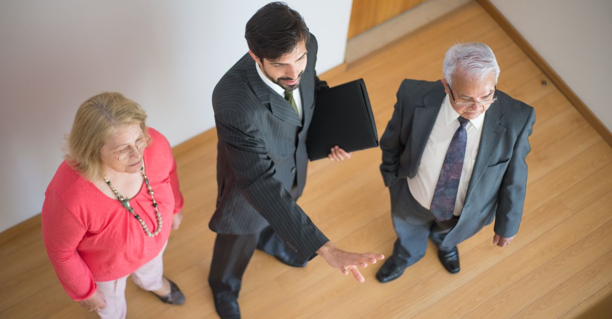 Bilingual hispanic real estate agent showing home to hispanic couple in Gwinnett County Atlanta suburb