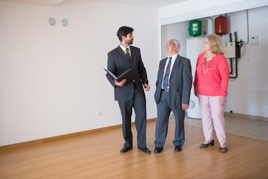 An elderly couple touring a home with a realtor, discussing real estate options.