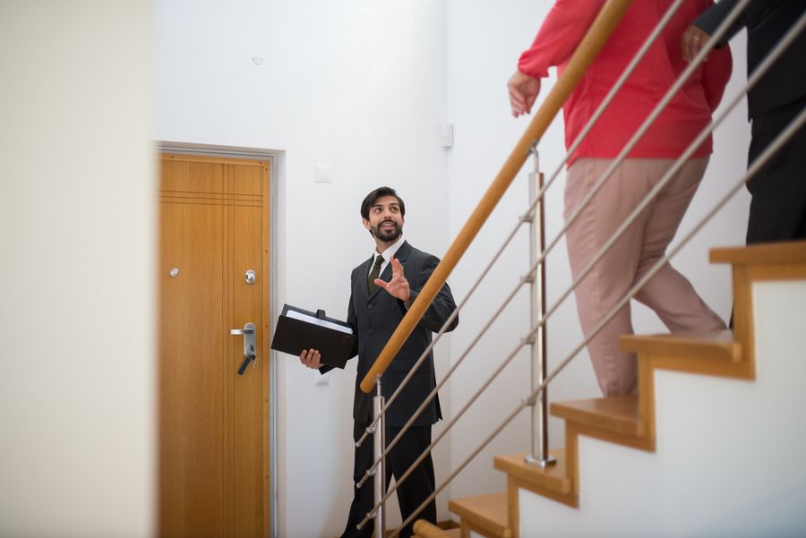 Real estate professional showing a property to a client