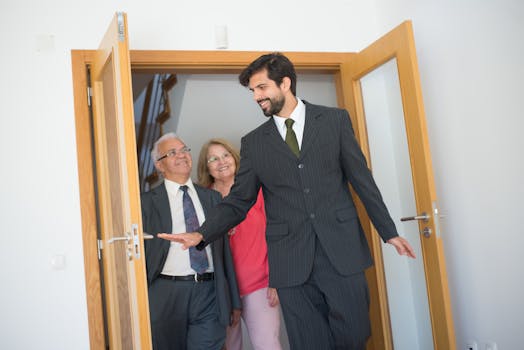 Smiling real estate agent showing an elegant home to a senior couple. Indoor setting in Portugal.