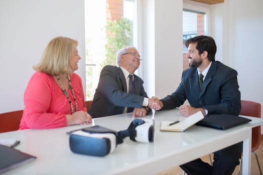 Business professionals engaged in a friendly handshake during a meeting.
