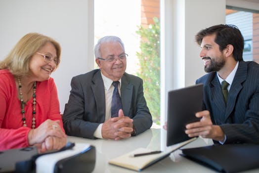 Elderly couple discussing real estate options with an agent in a modern office setting.