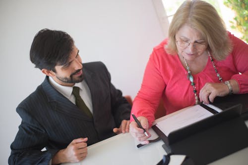 Woman Reading a Document Before Signing It