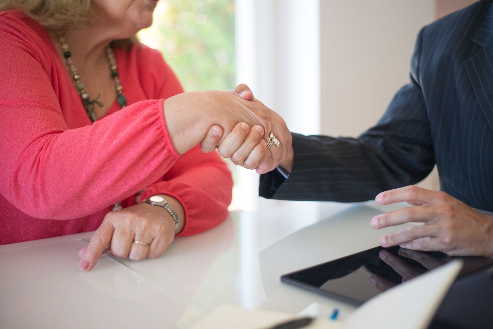 Close-up of a handshake between professionals symbolizing an agreement or deal.