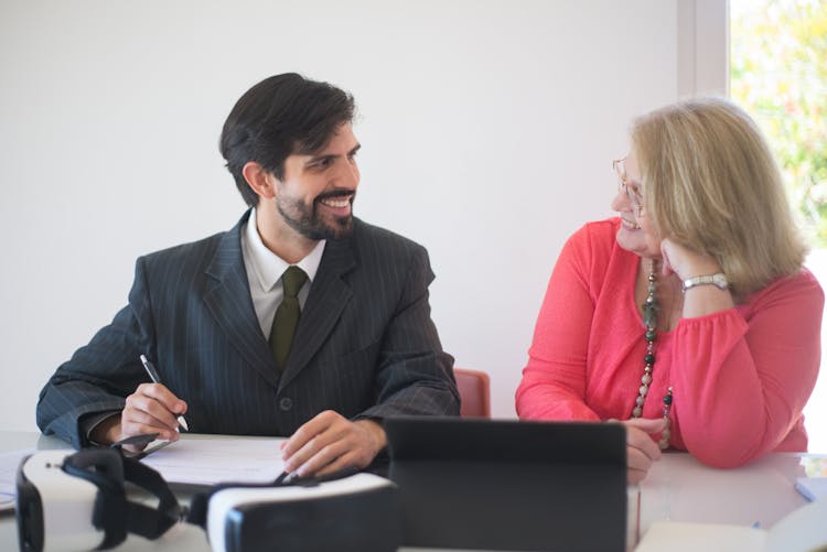 A Realtor And A Client During A Contract Signing