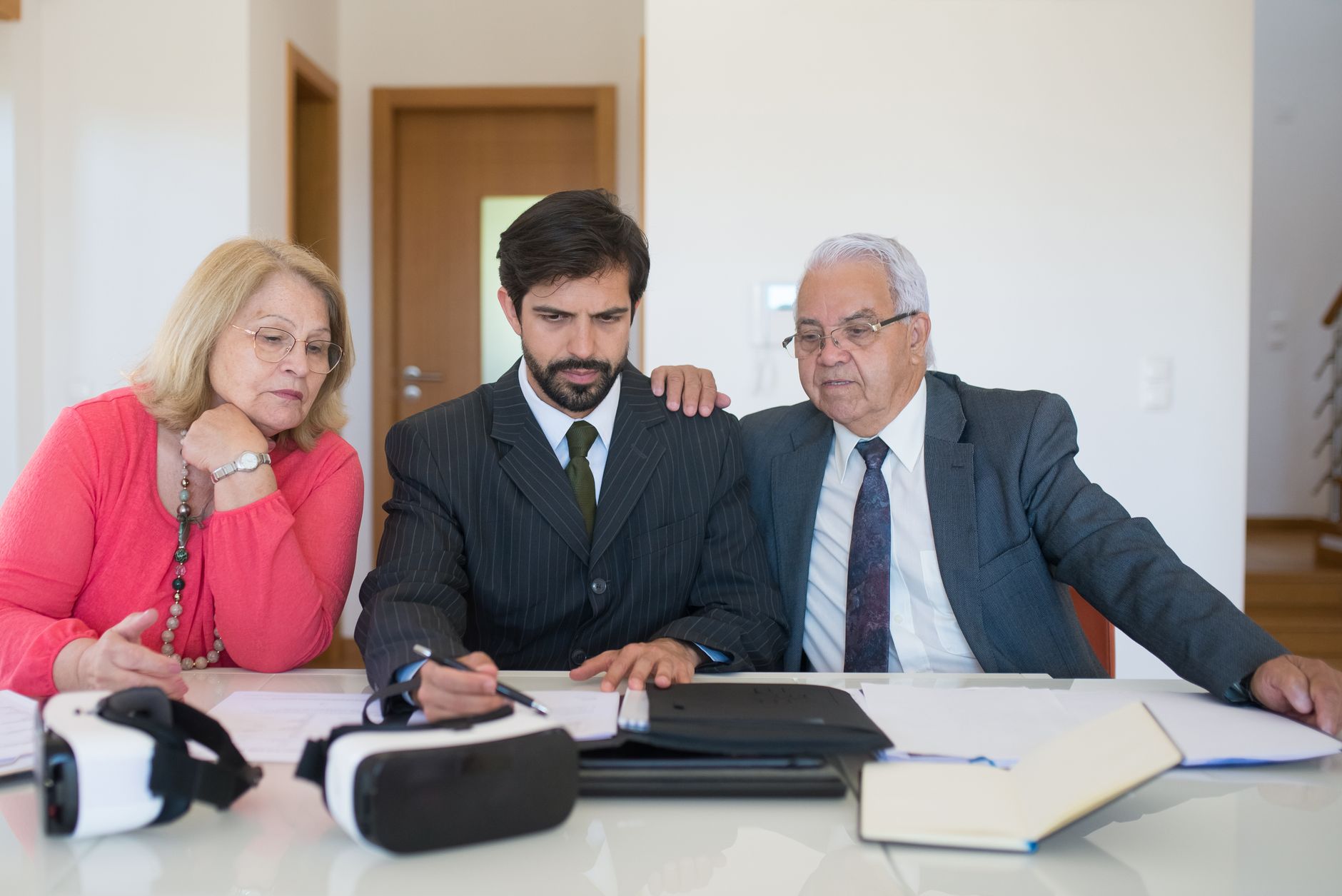 Person reviewing a real estate buyer representation agreement at a desk with a pen in hand