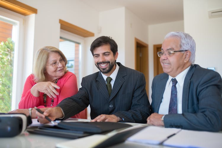 Real Estate Agent Having A Meeting To A Senior Couple