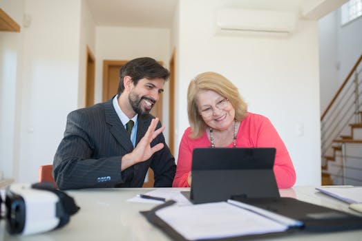A senior woman and businessman having a discussion in a modern office.