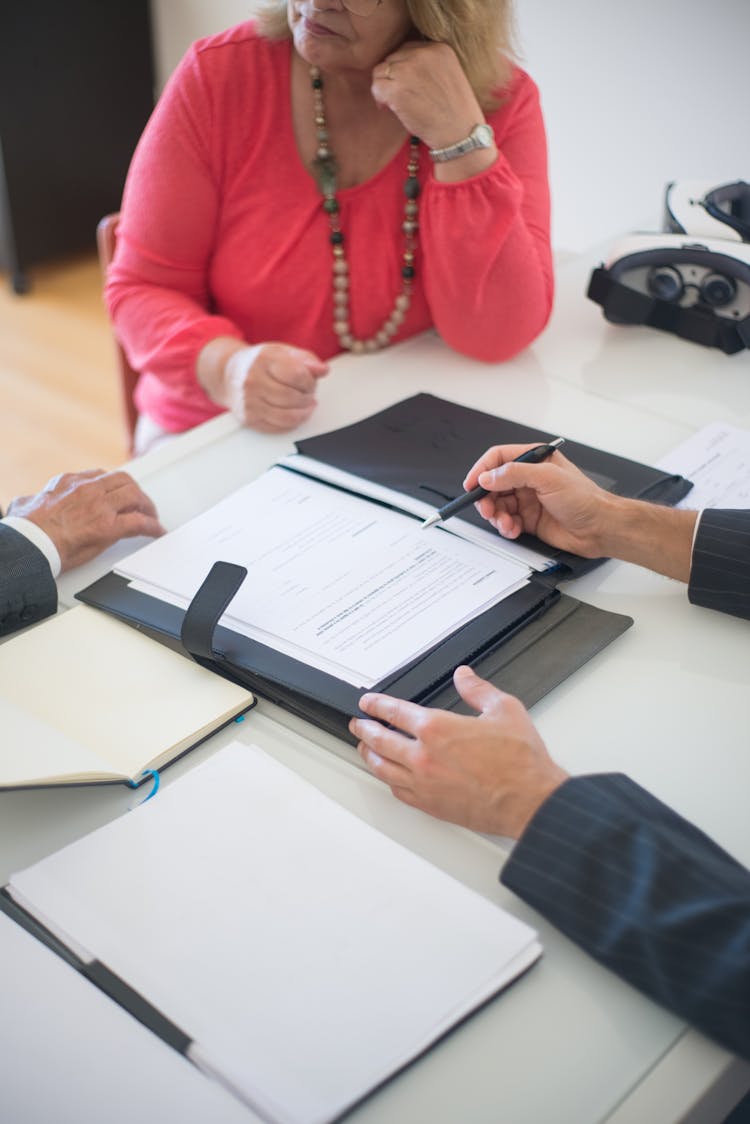 Person Discussing Real Estate Agreement Of Home Mortgage To Senior Couple