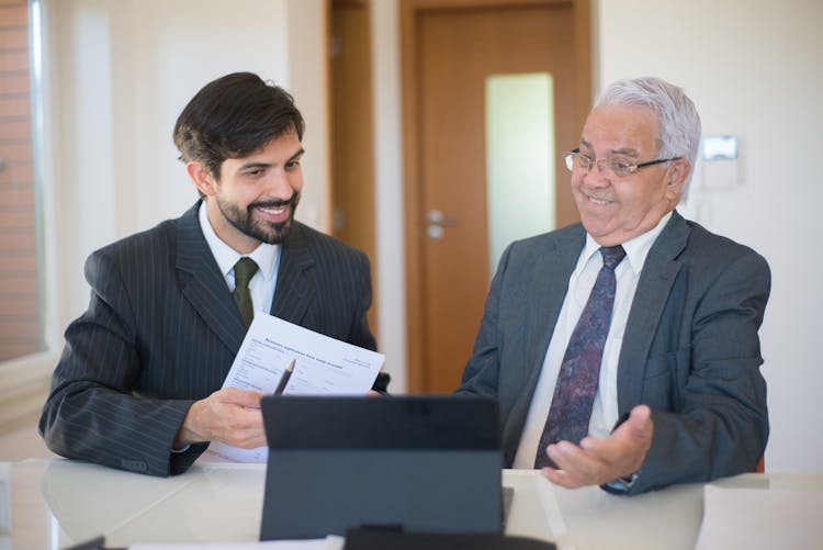 Salesman Discussing Real Estate To A Senior Man