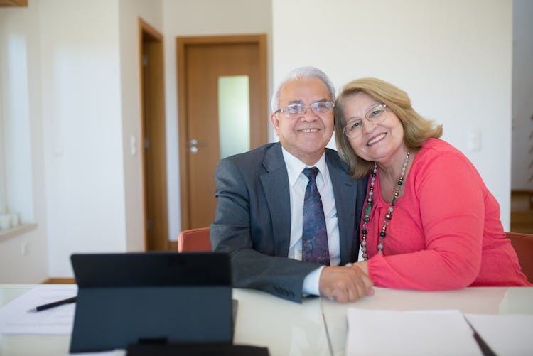 Happy Senior Couple Sitting Inside A Conference Room 