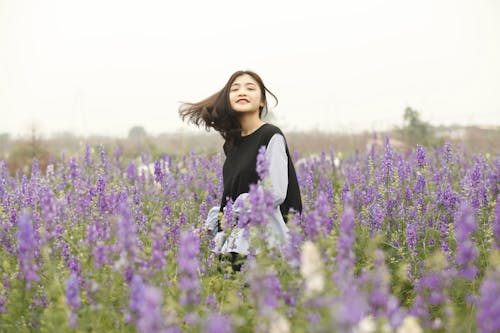 Free Woman With Black and White Long-sleeved Top on Garden Stock Photo