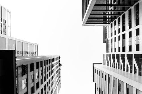Free Dramatic low-angle shot of black-and-white modern city buildings. Stock Photo