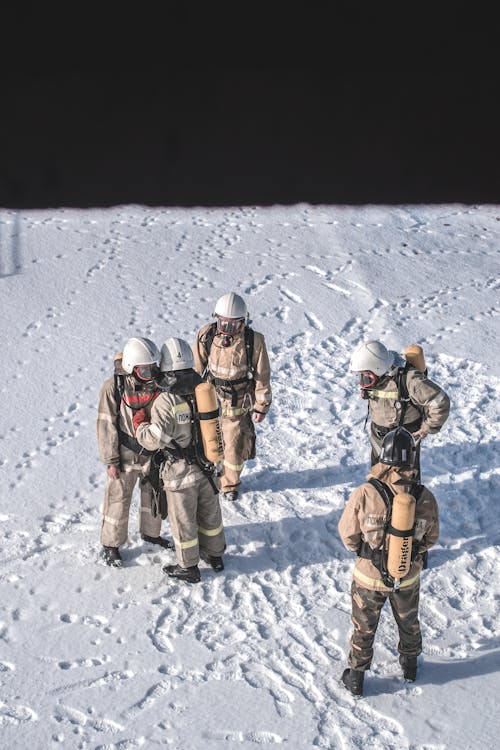 Firefighters Standing on Snow Covered Ground