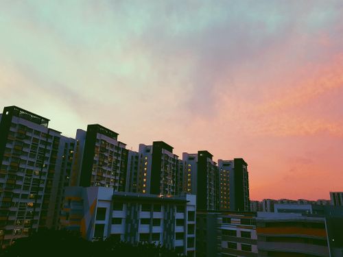 Free Beautiful high-rise buildings in Singapore under a vibrant sunset sky. Stock Photo