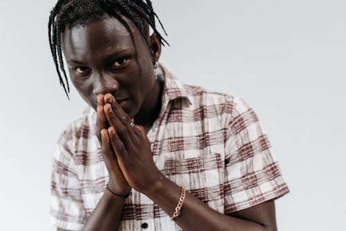 Man in a Red and White Shirt Praying