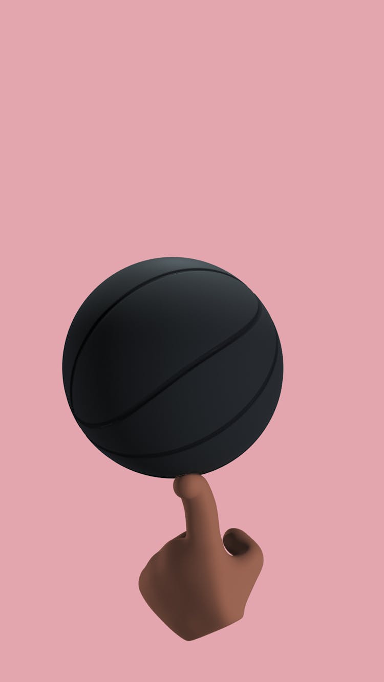 A Black Ball Balancing On A Finger