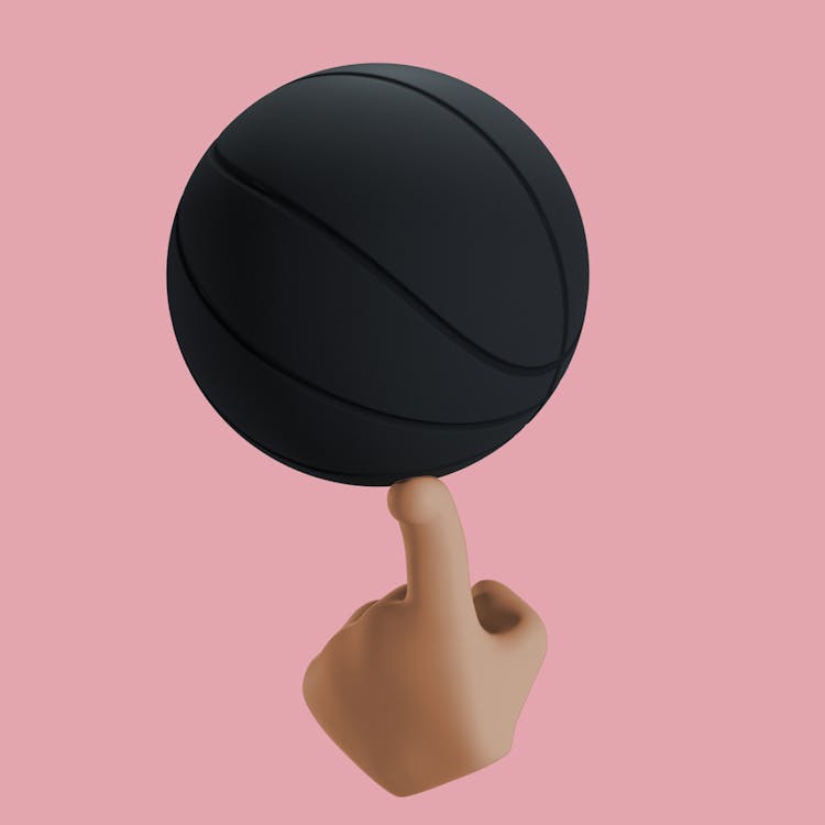 A Black Ball Balancing On A Finger