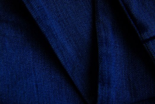 Detailed close-up of blue denim fabric showcasing texture and pattern.