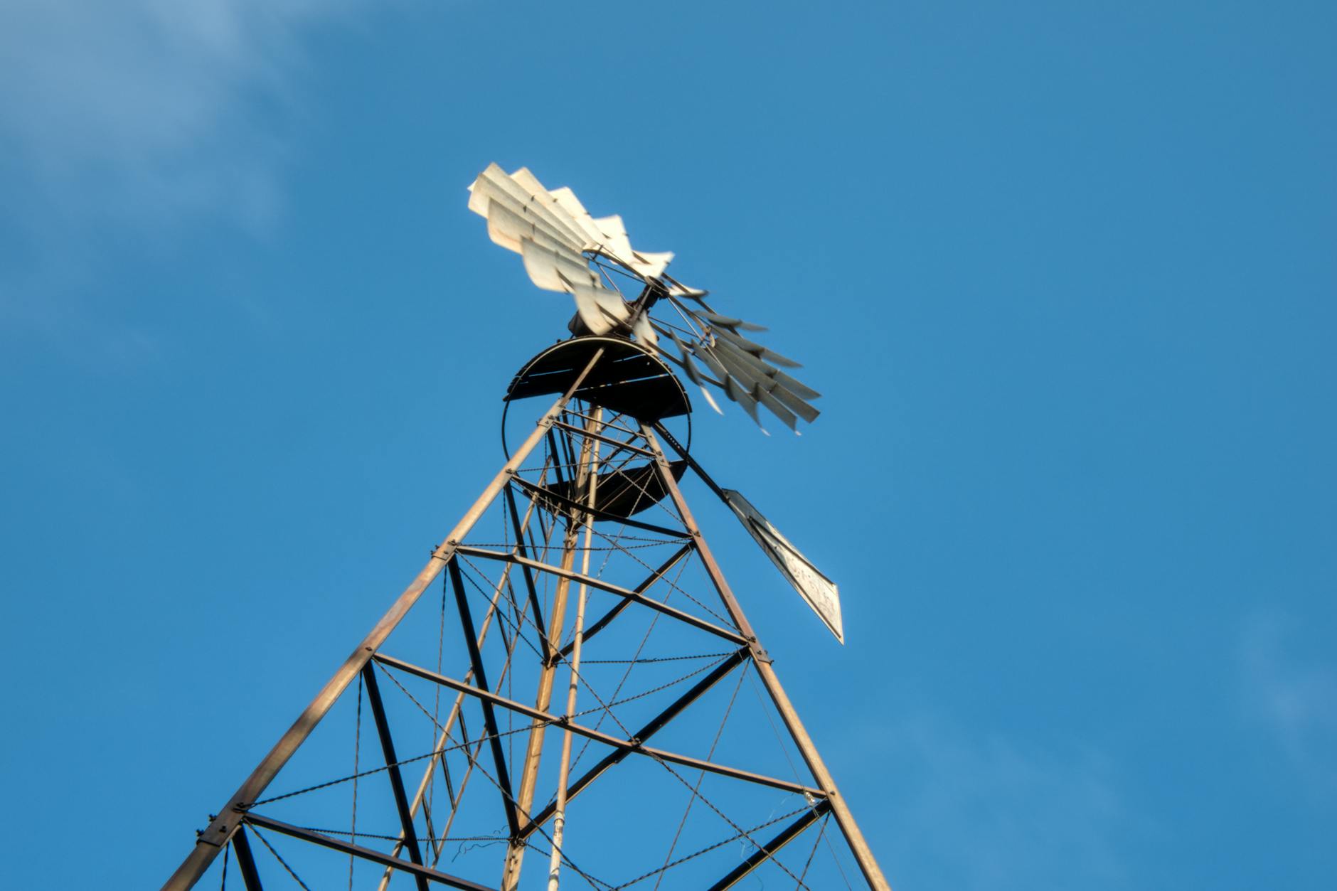 How AI is Streamlining Operations in the Energy Sector: Key Insights and Trends 4 A low-angle view of a windmill or wind turbine with a clear blue sky, symbolizing renewable energy.