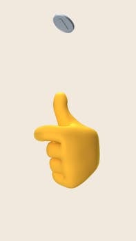 A 3D rendered yellow emoji hand flipping a coin against a plain background.