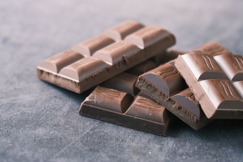 Free Delicious chocolate bars stacked artistically in a close-up shot. Stock Photo