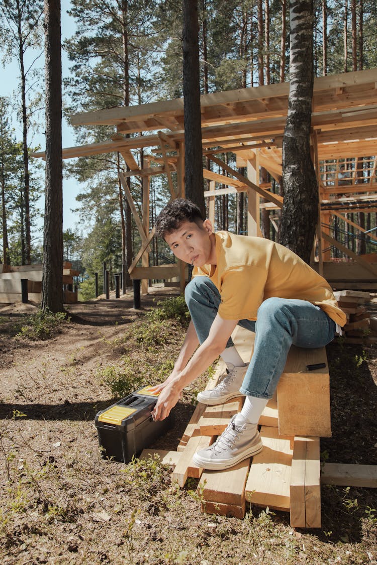 Man In Yellow Polo Shirt  Holding A Toolbox