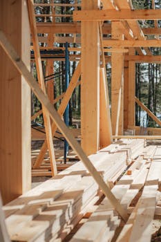 Sunlit construction site with wooden lumber arranged in rows. Perfect for building projects.