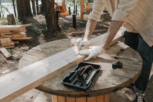 A Carpenter Tracing Outlining a Timber