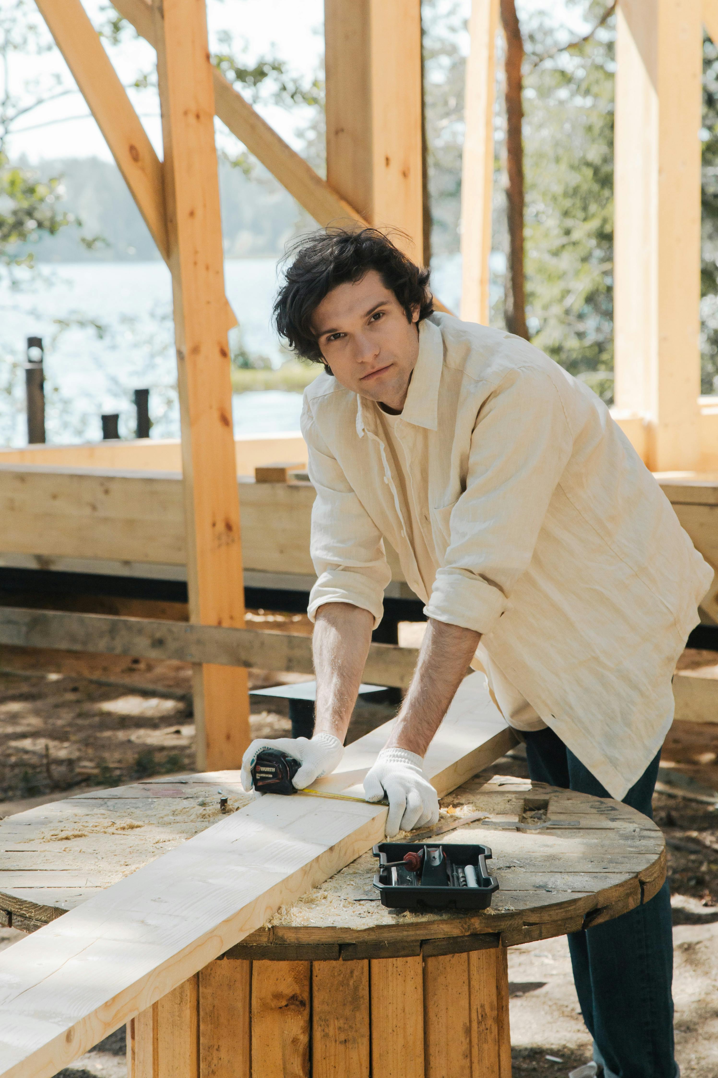 man measuring a wood