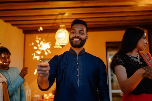 Free A joyous Diwali celebration with a group holding sparklers and smiling in vibrant attire. Stock Photo