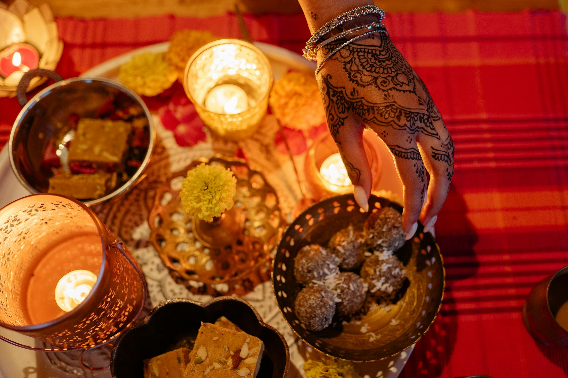 Puja Hinduism Photo by Yan Krukau from Pexels: https://www.pexels.com/photo/hand-of-a-woman-and-traditional-indian-treats-8818590/