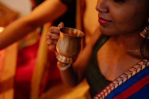 Free Close-up of a woman holding a traditional cup, celebrating a festive occasion. Stock Photo